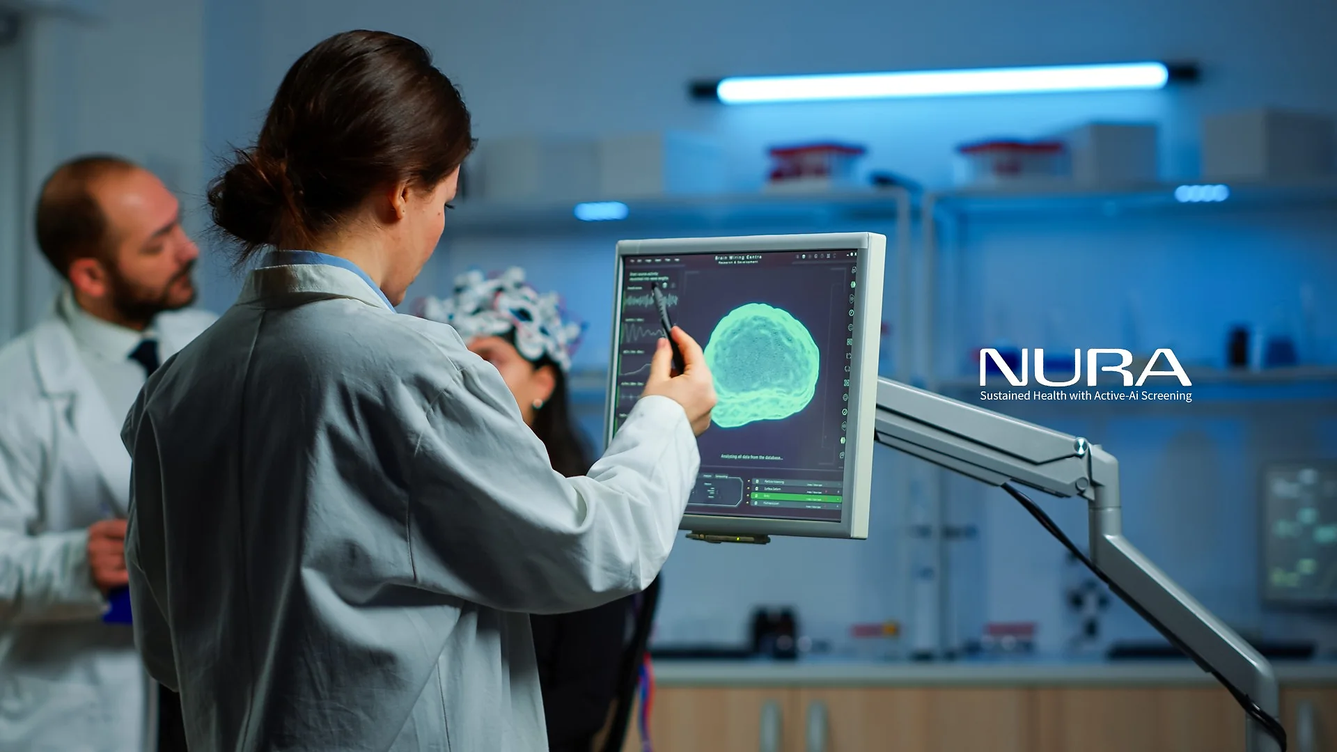 NURA — Sustained Health with Active-AI Screening: researcher points to a 3D brain scan on a clinical monitor